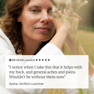 Woman smiling outdoors with review text about turmeric supplement benefits for aches and pains