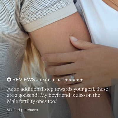 Couple embracing with customer testimonial praising Wild Nutrition fertility supplements for women and men, rated excellent on Reviews.io