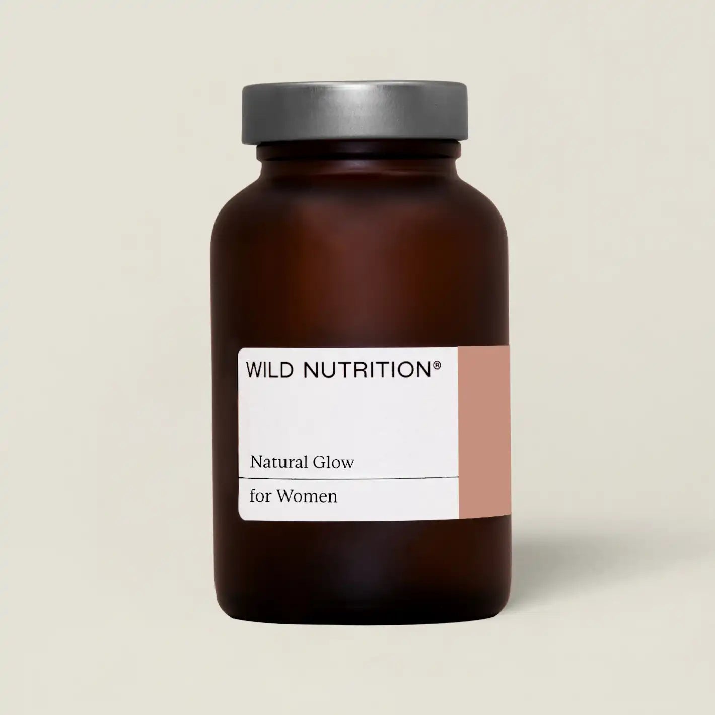Wild Nutrition Natural Glow supplement for women in a brown glass bottle to enhance skin health and glow.