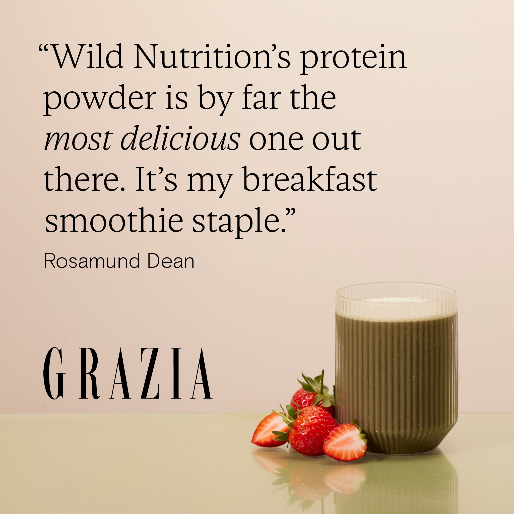 Quote about Wild Nutrition's protein powder with a smoothie and strawberries on a table.