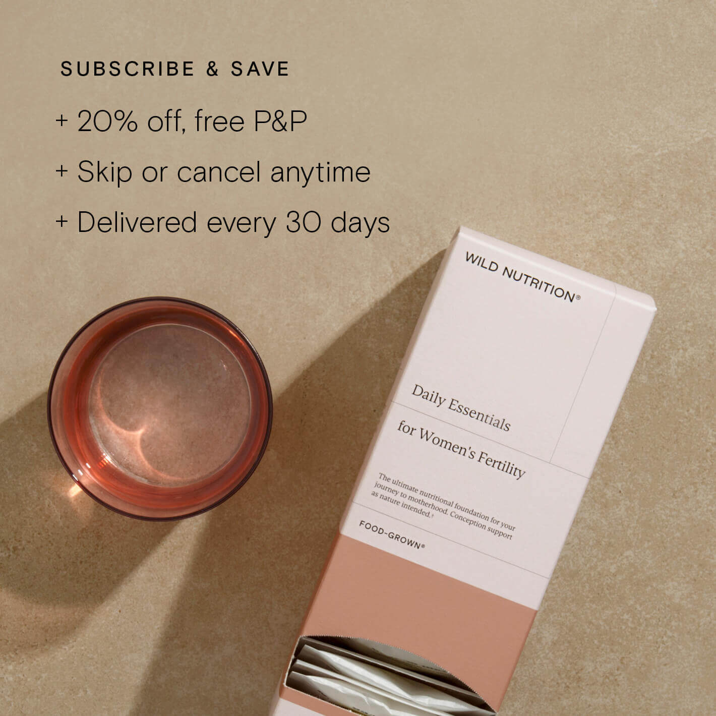 Daily Essentials for Women's Fertility supplement sachet with a glass beside it, highlighting subscription benefits.