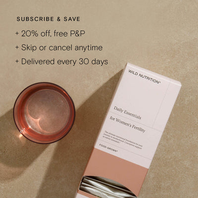 Daily Essentials for Women's Fertility supplement sachet with a glass beside it, highlighting subscription benefits.
