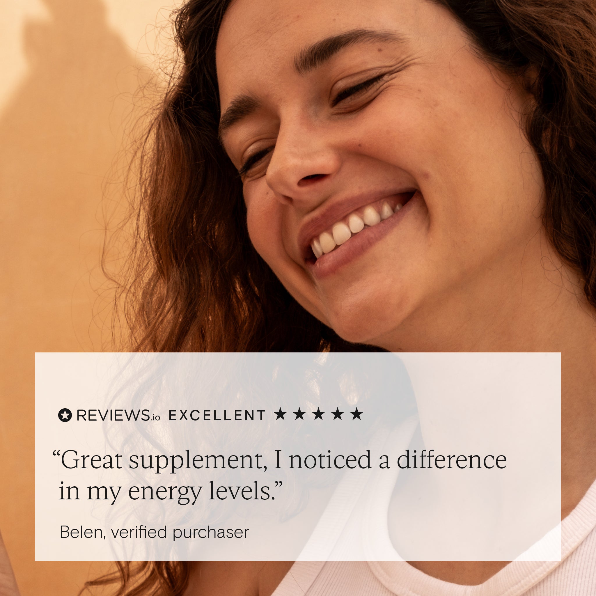 Happy woman smiling next to 5-star review for Wild Nutrition Daily Essentials for Women praising improved energy levels.