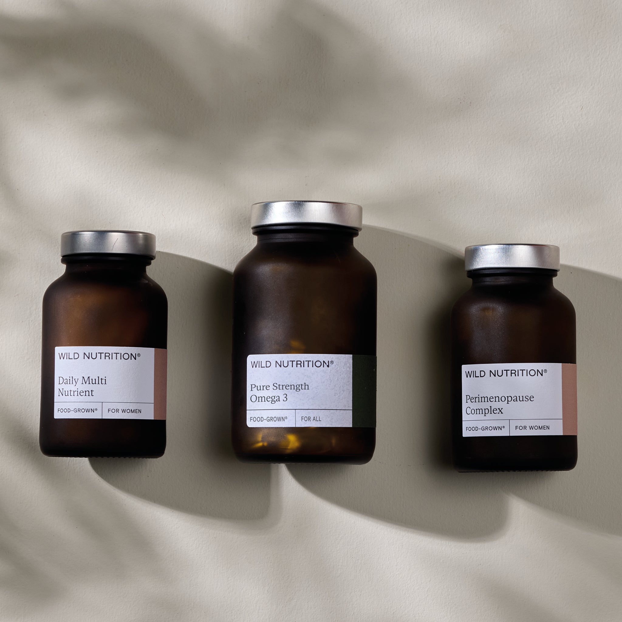 Wild Nutrition Perimenopause Support Trio including Daily Multi Nutrient, Pure Strength Omega 3, and Perimenopause Complex.