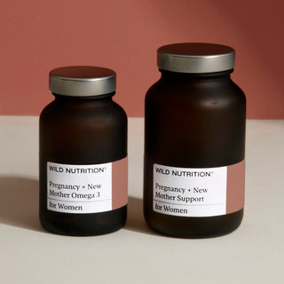 Two brown bottles labeled 'Pregnancy + New Mother Omega 3' and 'Pregnancy + New Mother Support' for women's health.