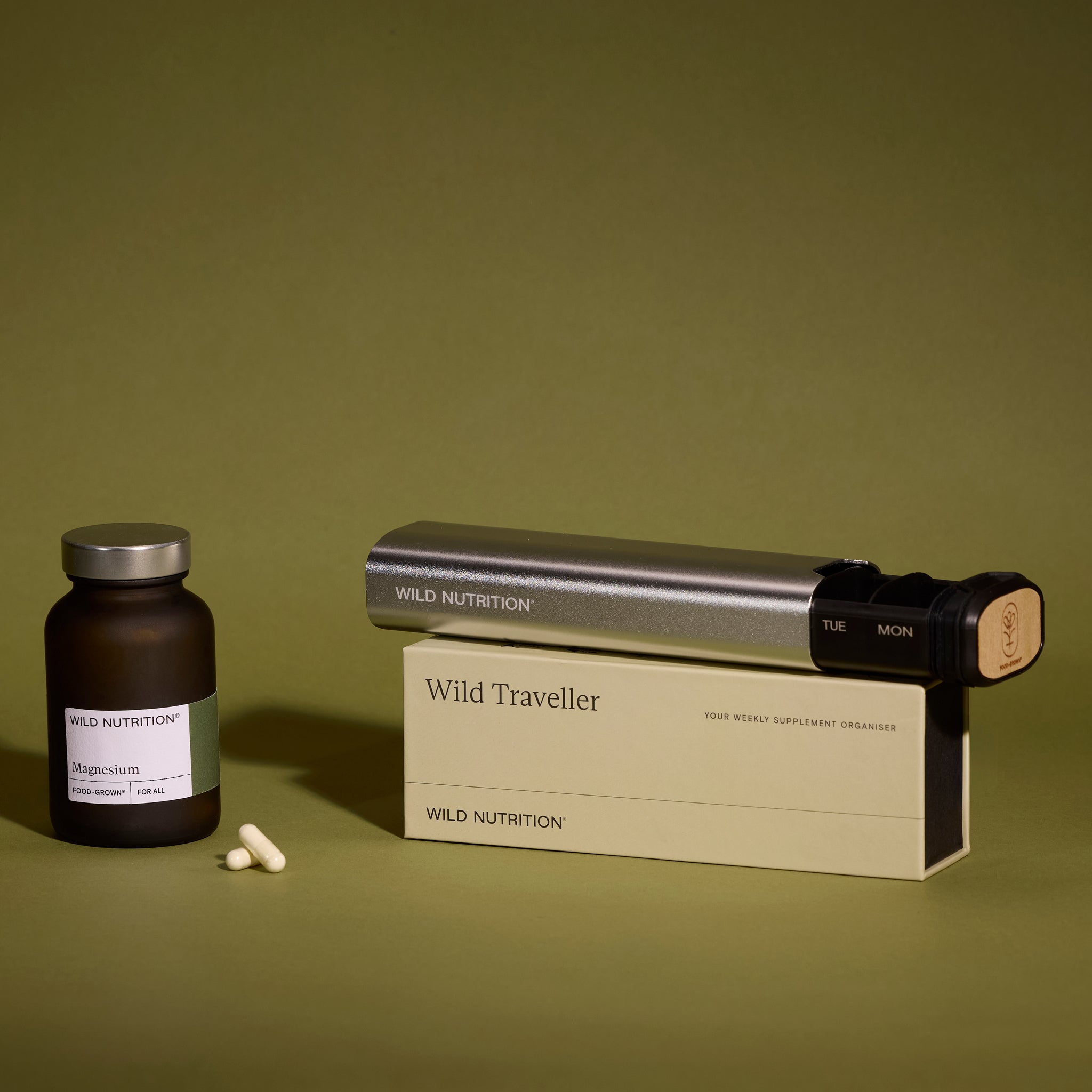 Wild Traveller organiser displayed next to Wild Nutrition KSM-66® Ashwagandha Plus supplement jar and capsules, highlighting product compatibility