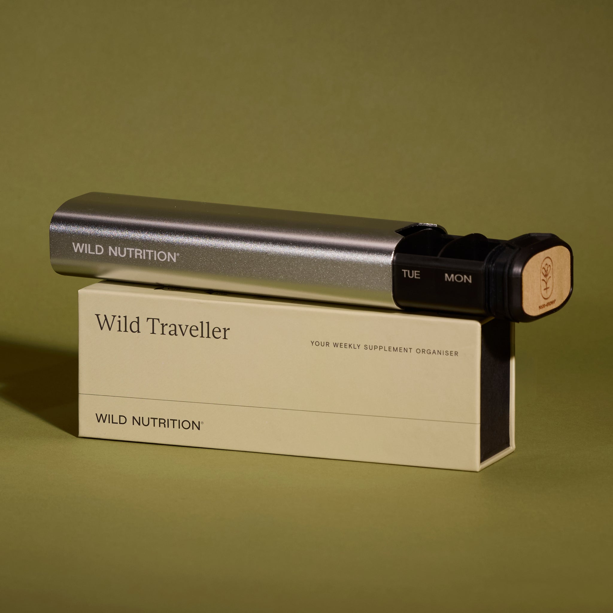 Wild Nutrition Weekly Supplement Organiser - Travel Pill BoxWild Nutrition Wild Traveller weekly supplement organiser in sleek silver case with sustainable wooden end cap, displayed on branded packaging