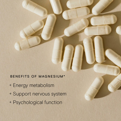 Scattered magnesium capsules highlighting benefits for energy metabolism, nervous system support, and psychological function.