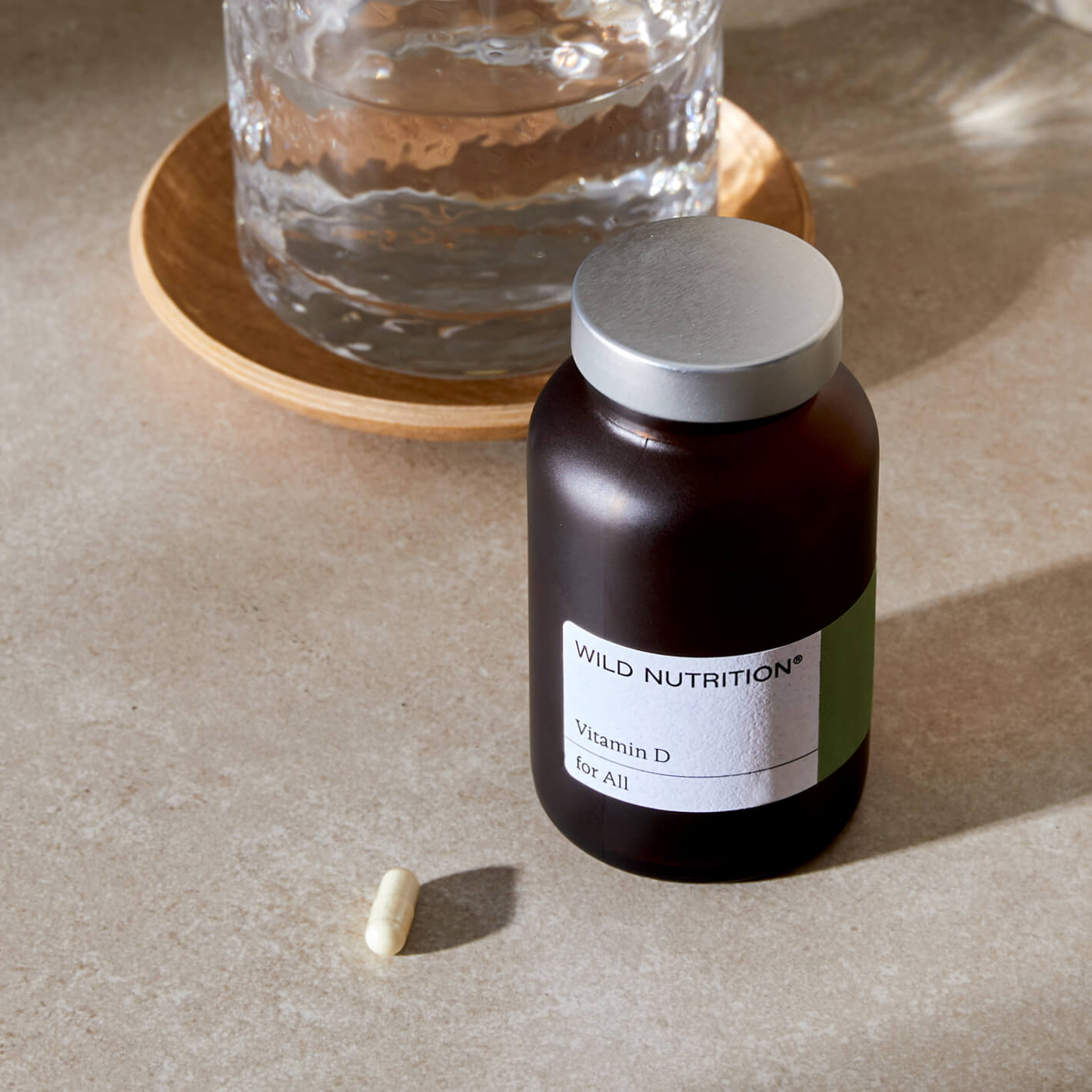 Wild Nutrition Vitamin D supplement bottle with a capsule beside it, promoting immune support and overall health.