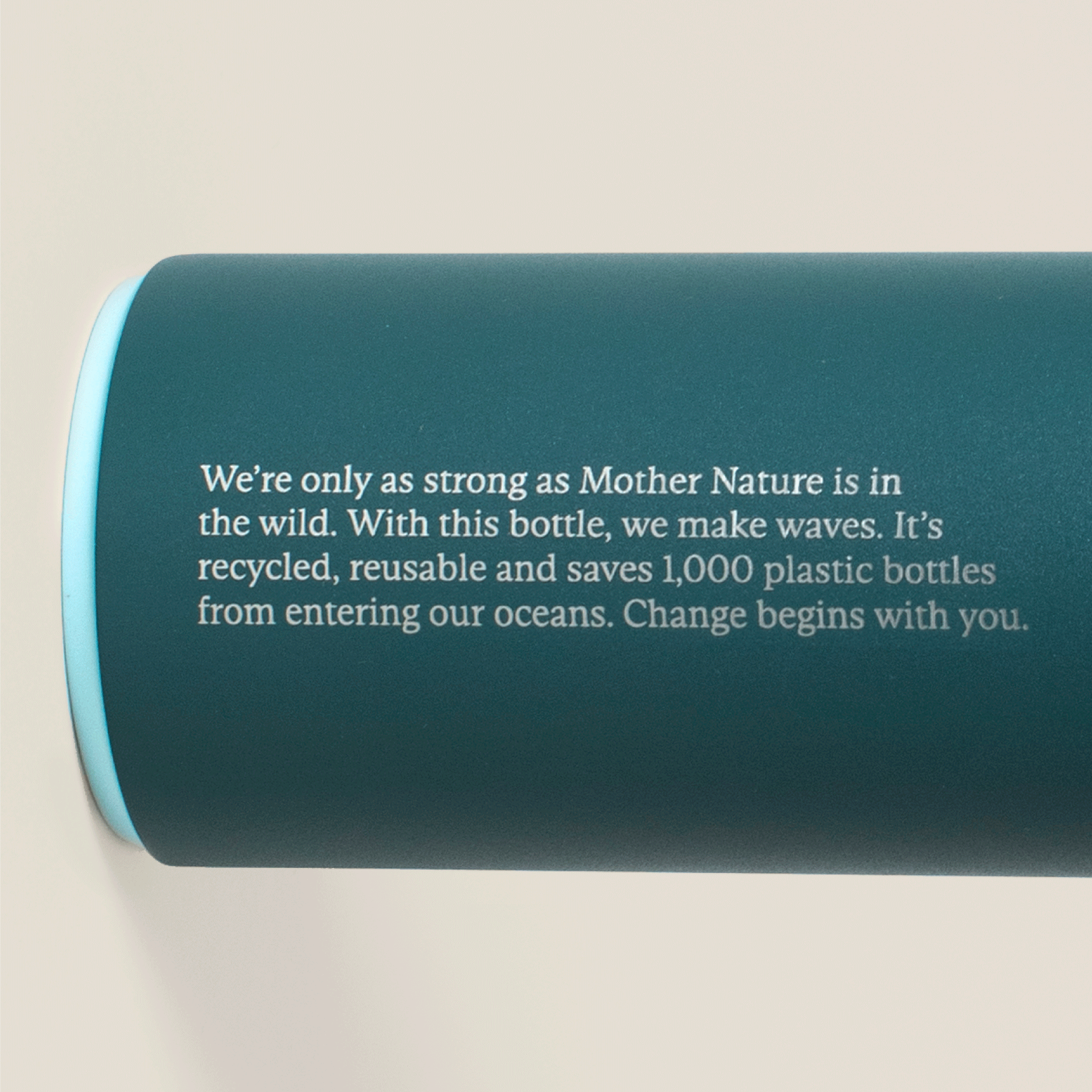 Close-up of Wild Nutrition Ocean Bottle showing printed message about being recycled, reusable, and saving 1,000 plastic bottles from oceans