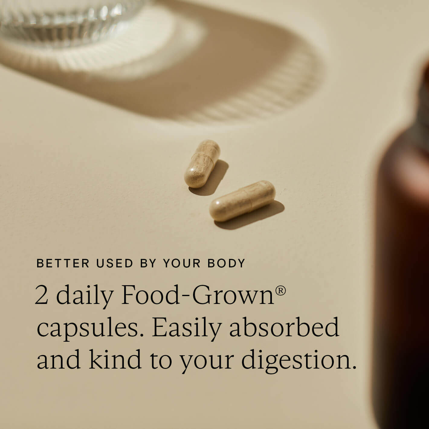 Food-Grown® capsules on a neutral background, promoting easy absorption and digestive support.