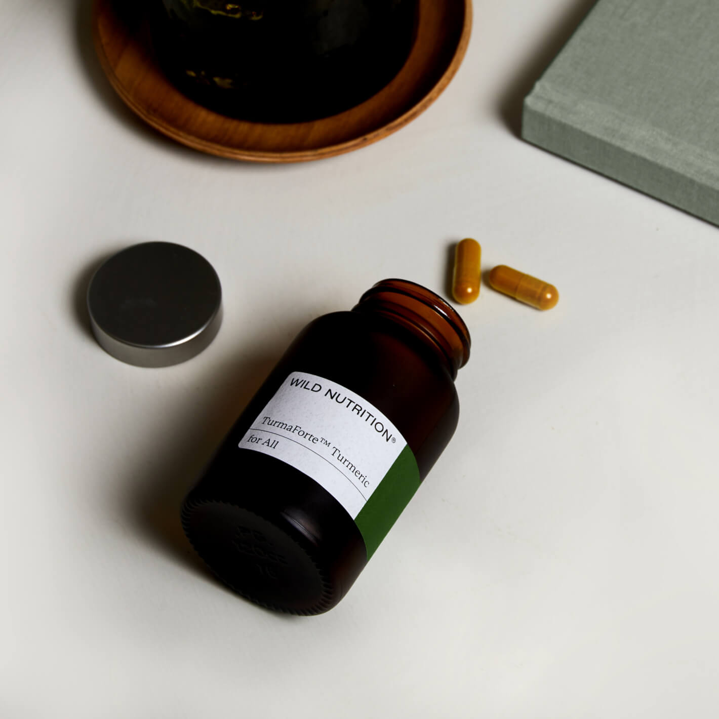 Wild Nutrition Turmeric supplement bottle with capsules, promoting health and wellness.