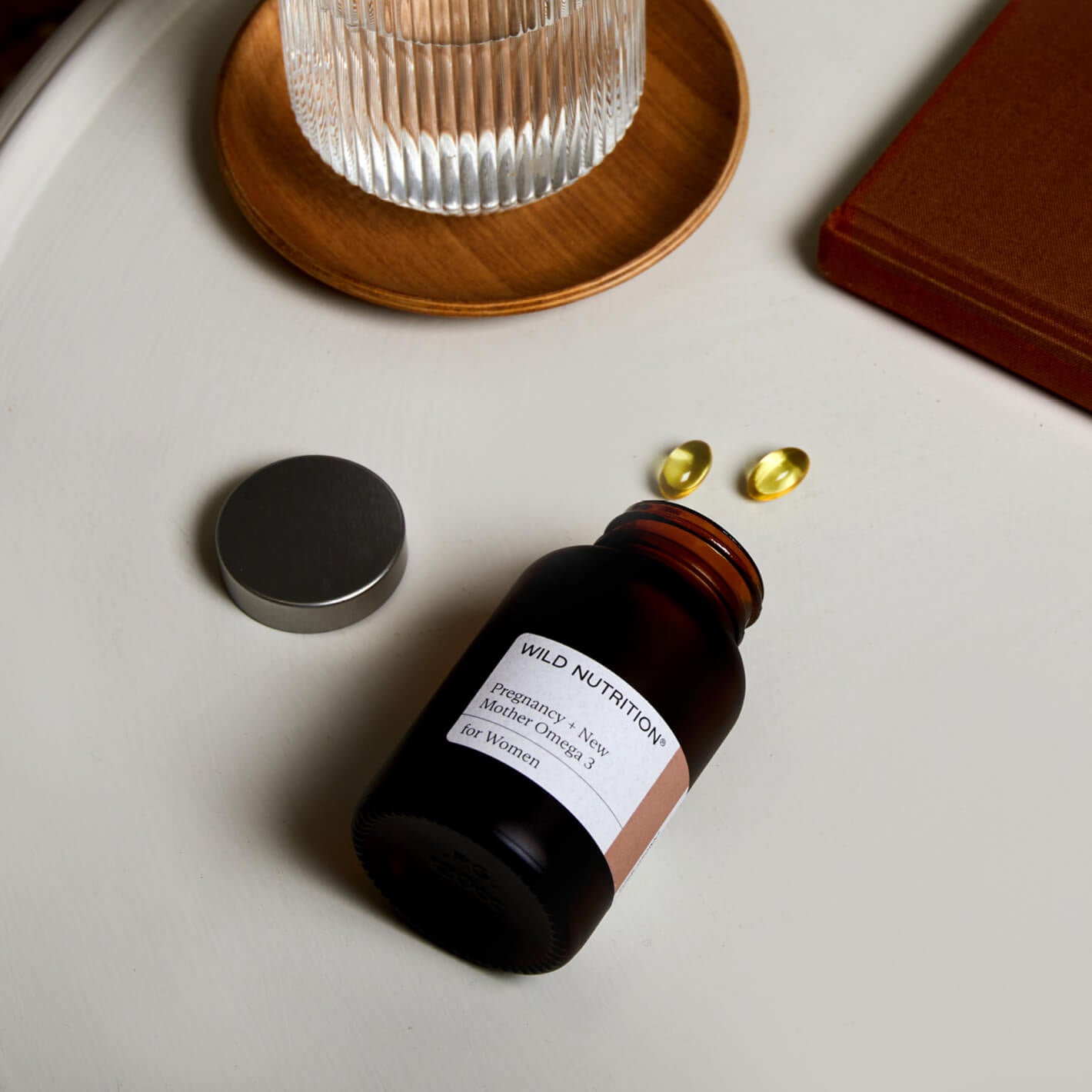 Wild Nutrition Pregnancy Omega 3 supplement bottle with capsules, promoting health for mothers and babies.